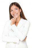 stock photo of business  - Thinking business woman smiling looking up at copy space - JPG 
