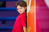 stock photo of kindergarten  - Portrait of cute little boy standing against wall in kindergarten - JPG 