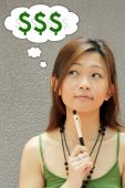 stock photo of money  - Asian Teenager Thinking of Money Matters Issues - JPG 