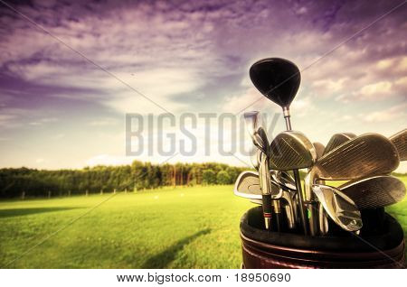 Picture or Photo of Professional golf gear on the golf field at sunset.