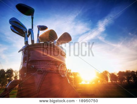 Picture or Photo of Professional golf gear on the golf course at sunset.