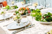 stock photo of restaurant  - catering table set service with silverware and glass stemware at restaurant before party - JPG 