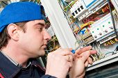 pic of wire  - One electrician working on a industrial panel mounting and assembling new wiring - JPG 