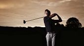 stock photo of golf  - Close up professional golf player in black shirt teeing - JPG 