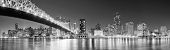 image of bridge  - Queensboro Bridge over New York City East River black and white at night with river reflections and midtown Manhattan skyline illuminated - JPG 