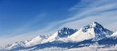 pic of blue  - Snow capped summit of Tatry high under clear blue panoramic skies - JPG 